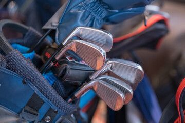 Golf clubs sit snugly in a blue bag ready for the next swing The polished metal gleams hinting at...