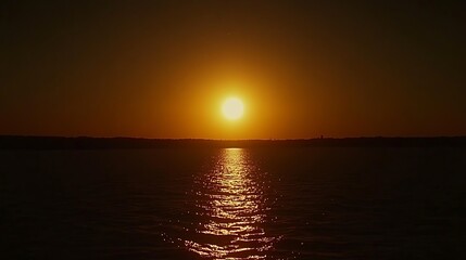 Fiery sunset over calm water.