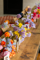 beautiful spring flower arrangements on long wooden farm table at brunch event 