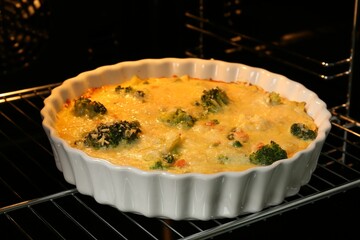 Delicious vegetable casserole in oven, closeup view