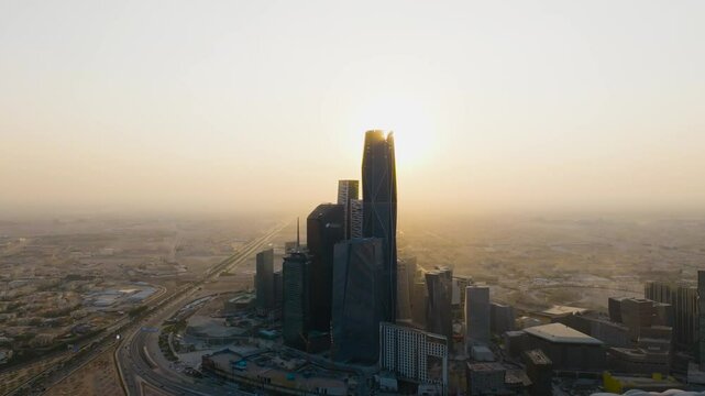 Riyadh City aerial view on KAFD towers at sunset showing the beautiful architecture and the sun rays, Saudi Arabia