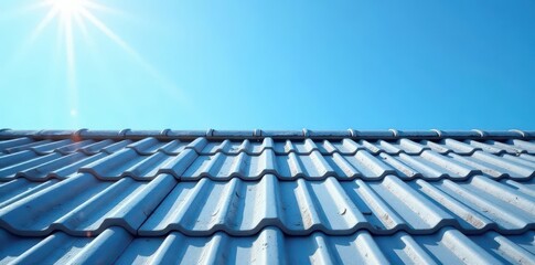 Fototapeta premium Grey roof tiles against clear blue sky Sunlight illuminates textured surface , home improvement, aerial view, detail