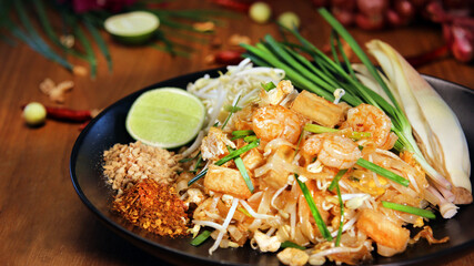 famous noodle food concept Delicious Pad Thai with shrimp, tofu, bean sprouts, and lime