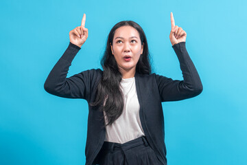 Asian woman with long black hair wearing a black cardigan and white shirt, looking surprised while...