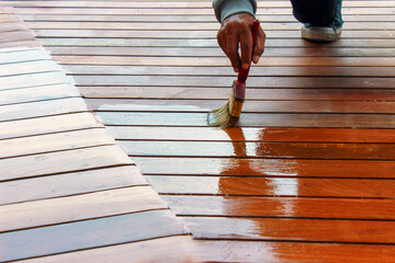 Applying varnish enhances wood's durability, appearance, and protection against environmental damage.