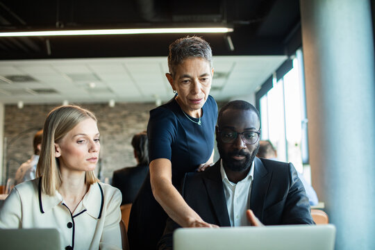 Diverse business professionals discussing project in modern office