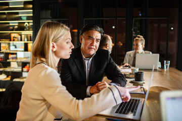 Diverse business professionals discussing project in modern office