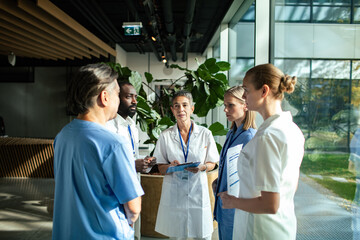 Medical team discussing patient care in hospital lobby