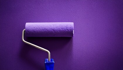 Obraz premium purple paint roller on textured purple wall