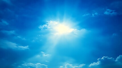 Bright sun shining through blue sky and clouds.