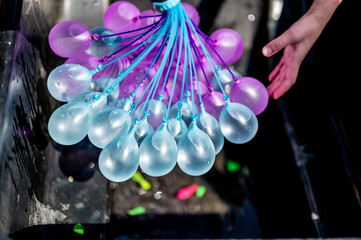 Rapid filling self sealing water balloons being inflated with a hose.