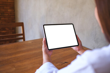 Mockup image of a woman holding digital tablet with blank desktop screen