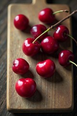 Fresh cherry with stems on a textured wooden board, ripe, summertime