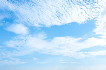 Serene Blue Sky with Wispy Clouds and Modern Building Under Construction