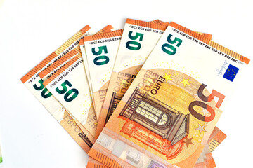 Paper money of European countries lies on a white background