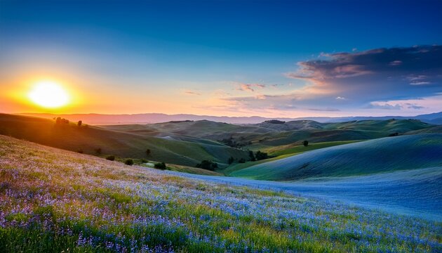 serene landscape featuring blue rolling hills and a warm sunset