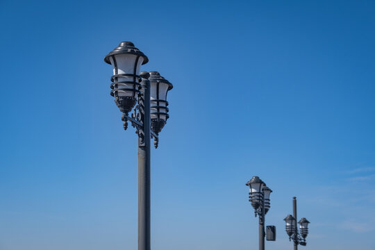 Decorative street lamps. Blue sky in the background.