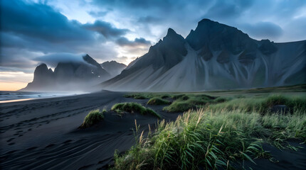 Majestic Icelandic Mountains Meet Black Sand Beach At Twilight, A Breathtaking Coastal Scene Under Moody Skies