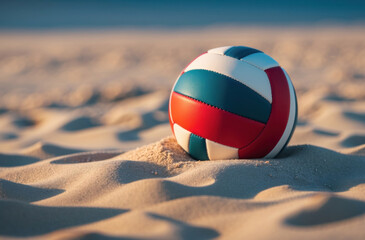 A volleyball resting on a sandy surface on a beach.
