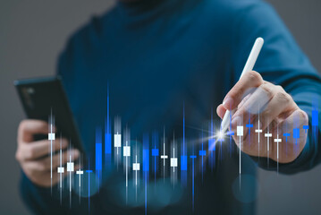 A person analyzing stock market trends with a digital pen, using mobile technology to track...