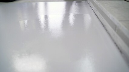 Epoxy resin floor drying: reflecting lights on wet surface