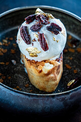 A stunning winter dessert presents a delightful combination of pecan, ice cream, and golden accents