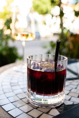 Vibrant drinks sit on a mosaic table, basking in warm sunlight on a relaxing afternoon