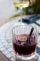 A delicious cocktail sits on a mosaic table, inviting relaxation and enjoyment in the sun