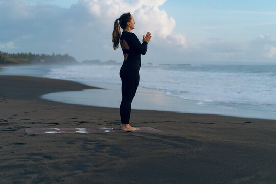 Woman doing yoga on beach