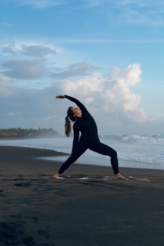 Woman doing yoga on beach