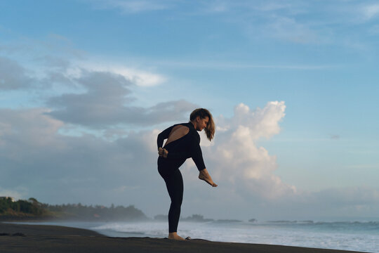 Woman doing yoga on beach