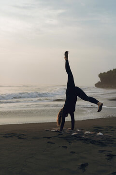 Woman doing yoga on beach