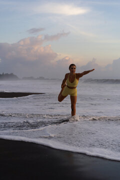 Indonesia, Bali, woman practising yoga at the beach