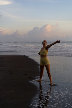 Indonesia, Bali, woman practising yoga at the beach