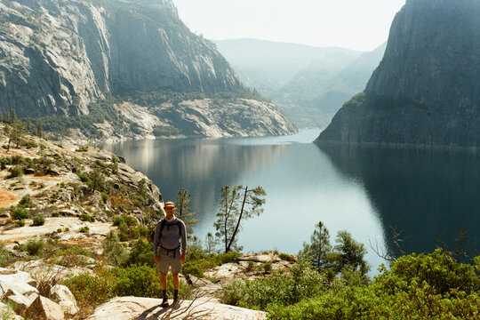 Hiker Overlooking Mountain Lake in California