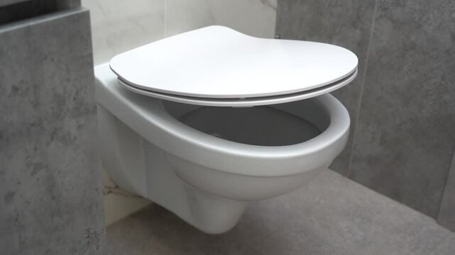 Toilet bowl with automatic lid as a symbol of urological problems