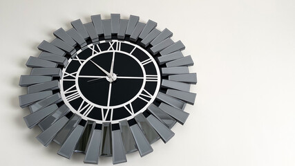 Elegant black and silver wall clock with a mirrored geometric frame. Stylish timepiece featuring...