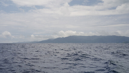 side view from boat in Indian ocean sailing between Seychelles islands in daytime