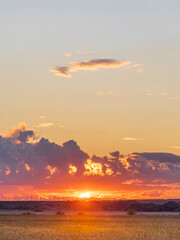 The sky is orange and the sun is setting