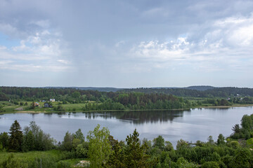 A lake with a cloudy sky in the background