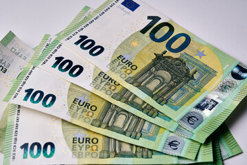 A stack of euro 100 bills. The bills are green and have a star on them. Concept of wealth and...