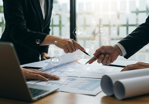 Business team discussing financial strategy with currency icons. Close-up of hands pointing at business documents with digital currency symbols overlay, representing finance and  investment 