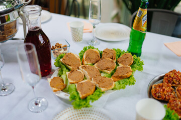 A served table with simple appetizers. sandwiches with pate