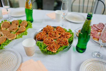 A served table with simple appetizers. sandwiches with baked eggplant