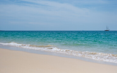 Landscape image of tropical white beach with blue sea and sky background