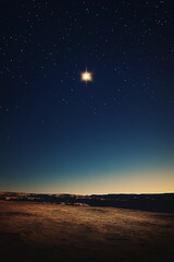 Starry night over a desert landscape. A bright celestial body shines above a vast, dusty expanse