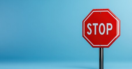 Obraz premium Stop Sign Against a Blue Background: A Minimalist Representation of Caution and Halt
