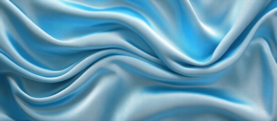 Fototapeta premium Smooth flowing light blue fabric creating soft elegant waves