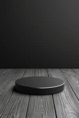 Empty black circular podium on wooden floor