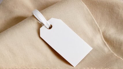 Fototapeta premium Customizable clothing tag mockup on soft fabric for branding and design projects.
